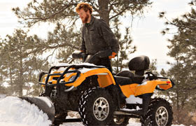 An ATV plowing snow