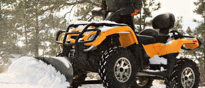 An ATV plowing snow